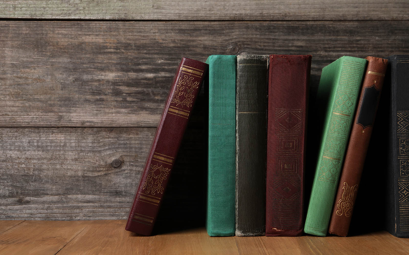 Different,Old,Hardcover,Books,On,Wooden,Table,,Space,For,Text