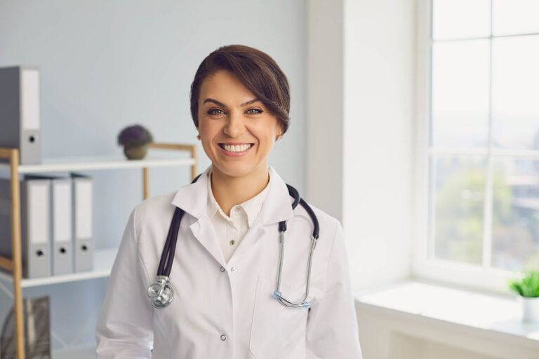 Female,Doctor,Looking,At,Camera,In,Hospital.,Medical,Worker,Communicating