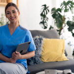 Young,Confident,Nurse,Looking,At,Camera,,Holding,Digital,Tablet,,Posing