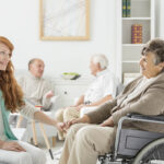Young,Pretty,Nurse,Talking,To,Old,Lady,In,Wheelchair