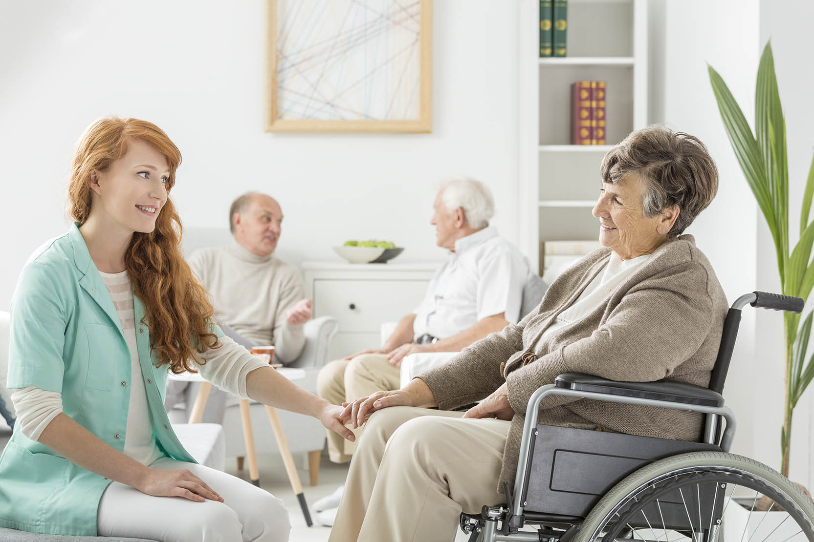 Young,Pretty,Nurse,Talking,To,Old,Lady,In,Wheelchair
