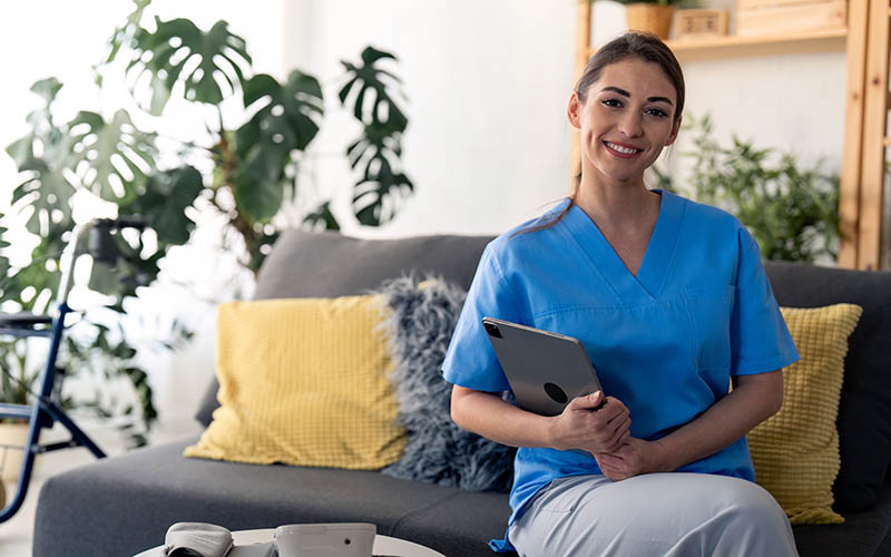 Young,Confident,Nurse,Looking,At,Camera,,Holding,Digital,Tablet,,Posing